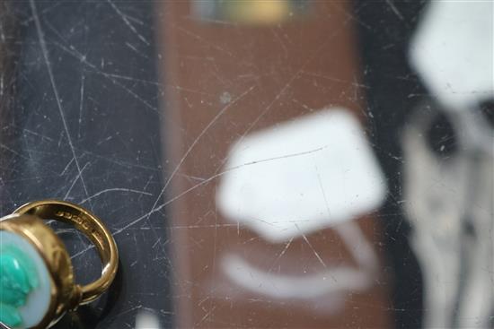 A 1950s 22ct gold and sardonyx set oval ring, carved with head of a Roman soldier to sinister, size K.